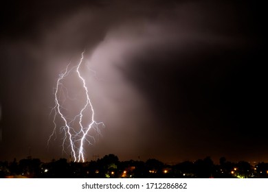 Lightning strikes at night during a severe thunderstorm over the city of Mendoza, Argentina - Shutterstock ID 1712286862