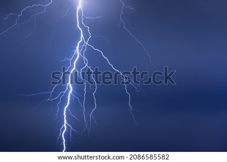 Lightning or thunderbolt in night storm in dramatic blue light