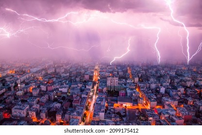 Lightning thunderstorm flash over the city at blue night sky - Lightning storm over city in blue light