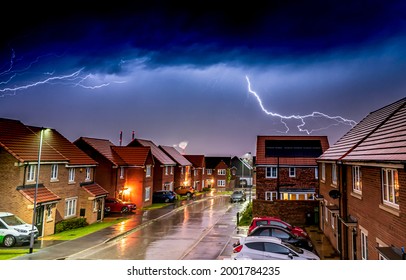 Lightning in a thunderstorm over the town. Lightning in night sky. Lightning over the town street