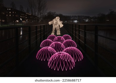 Lightpainting PHOTOGRAPH;  person looks at half orbs  - Shutterstock ID 2258688717