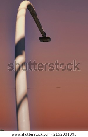 Lightpole with a pink sky background