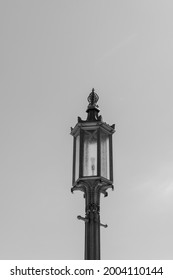 Lightpost, lamp, and light bulb with open space around it.