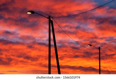 Lightpost in silhouette with sunset clouds in the background