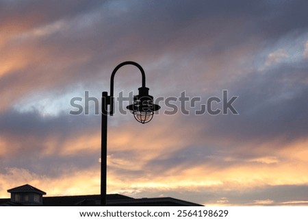 Lightpost surrounded by a blazing sunset.