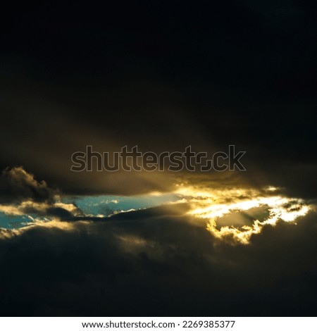 Lightray between clouds on sky