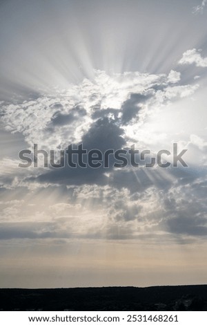 lightrays in the sky with big clouds