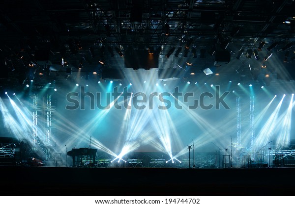 Lights\
beams on stage with piano and musical\
instruments