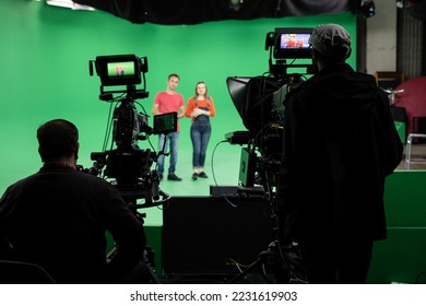 Lights.. Camera.. Action! Woman and Man anchor reporting news in studio. Film and Tv industry. - Shutterstock ID 2231619903