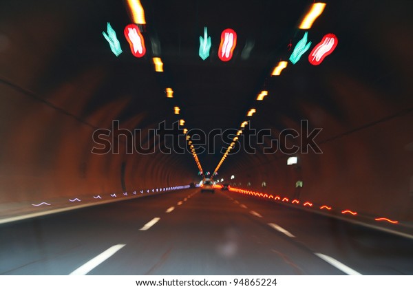 Lights and car in\
tunnel.