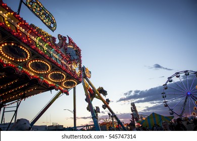 The lights of a carnival ride during  sunset 