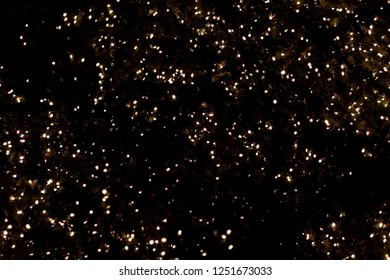 Lights of a Christmas tree with a dark background.