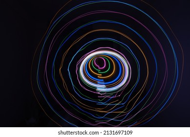 Lights Circles With Different Colour, Isolated On Black Background. Long Exposure Light Painting Photo Of Abstract Round Form. Swirl Trail Effect. Picture For Creative Wallpaper, Design Art Work