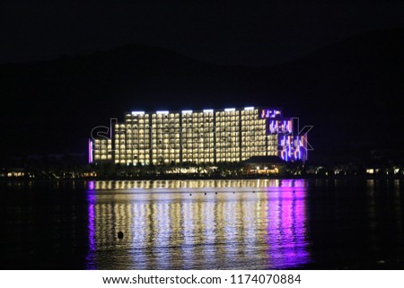 Lights of the hotel reflected in the sea