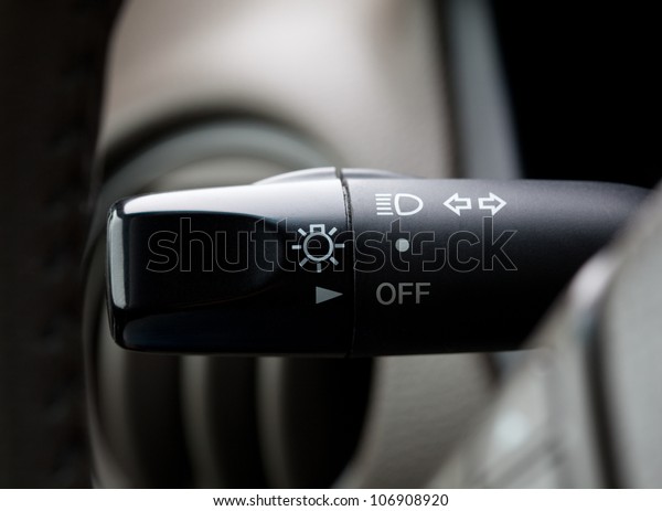 Lights on/off\
switch in a car, shallow focus\
depth
