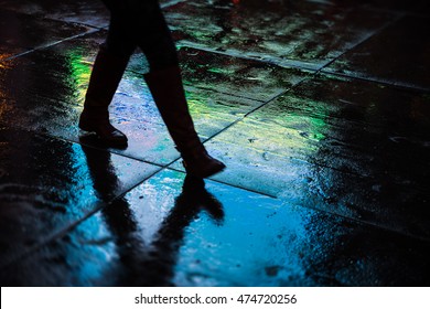 Lights And Shadows Of New York City. Abstract Blurred Image Of NYC Streets After Rain With Reflections On Wet Asphalt. Silhouettes Of People Walking On The Street