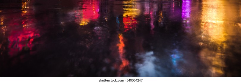 Lights and shadows of New York City. NYC streets after rain with reflections on wet asphalt. 