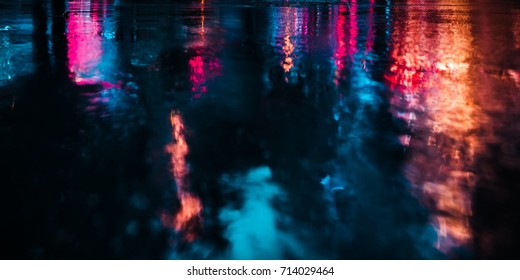 Lights and shadows of New York City. Soft focus image of NYC streets after rain with reflections on wet asphalt