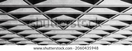Lights and shadows on ceiling of minimal industrial building. Abstract modern business architecture photo. Geometrical pattern with polygonal and triangular pattern in perspective.