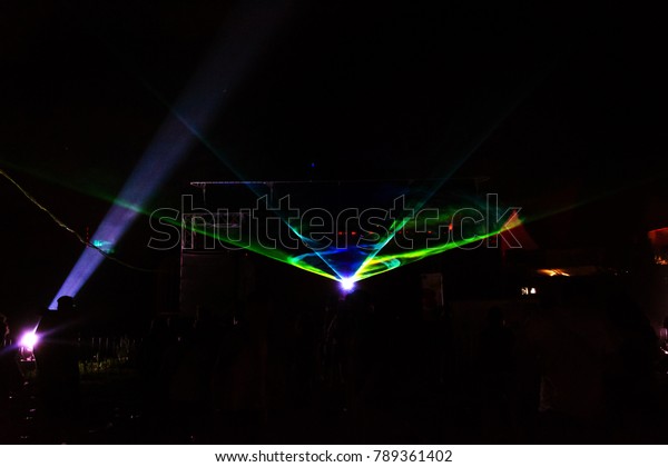 Lights show. Laser show. Nightclub dj parties use\
music, dancing sound with bright light. club night light dj party\
club. With car for smoke and lights. Creative Light show on open\
nightclub scene