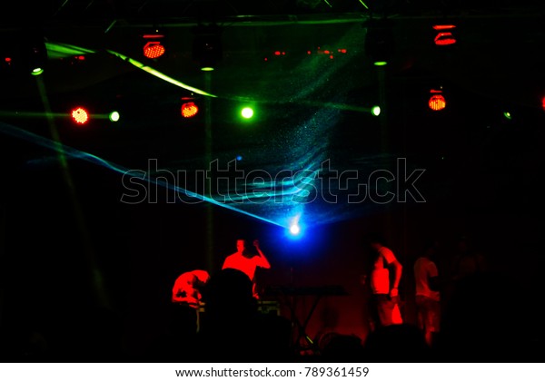 Lights show. Laser show. Nightclub dj parties use\
music, dancing sound with bright light. club night light dj party\
club. With car for smoke and lights. Creative Light show on open\
nightclub scene