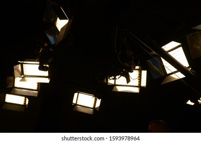 Lights In TV News Studio. Modern Cinema And TV Light Equipment. Sound Stage With A Large Lighting Grid. Production For Entertainment Industry. Lighting Equipment And Cameras For TV Show.