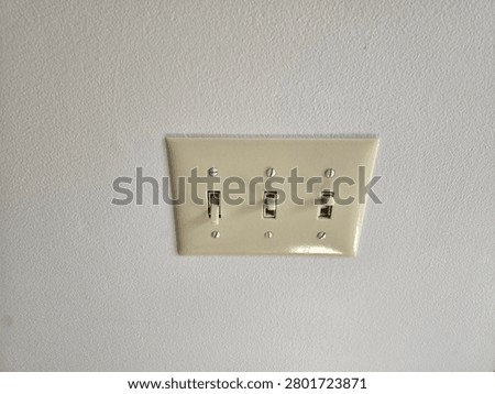 Lightswitch panel with 3 switches.
