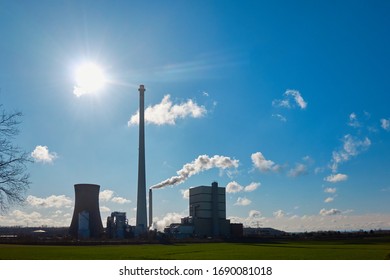 Lignite Power Plant Behind A Green Field In Brilliant Sunshine