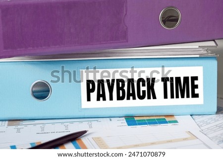 A lignt blue folder with the label PAYBACK TIME.