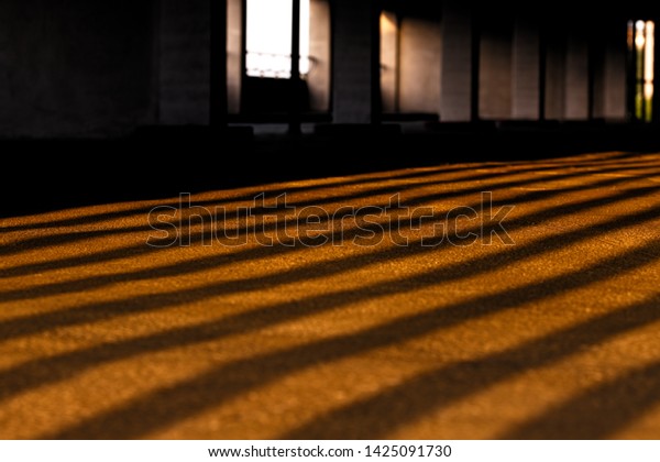 Ligth and shadows of the columns on the floor of
the building with parking
