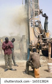 LIGUIDIMALGEM,  BURKINA FASO - FEBRUARY 24: In Africa The Water Is Underground, The Worker Drill A Well Using A Very Old Drill And Breathes A Fine Dust, February 24, 2007