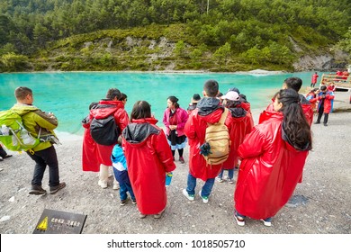 Lijiang, China - September 22, 2017: Tourists Listen Tour Guide At The White Water River In Blue Moon Valley, One Of The China Top Travel Destinations.