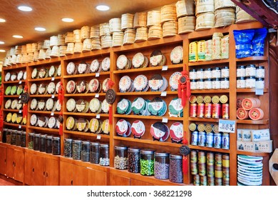 LIJIANG, YUNNAN PROVINCE, CHINA - OCTOBER 23, 2015: Wide range of traditional Chinese tea on wooden shelves at tea shop in the Old Town of Lijiang. Bricks of Yunnan Puer and disks of black tea.