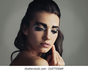 I Like To Be A Little Different. Studio Shot Of An Attractive Young Woman Wearing Bold Eye Makeup.