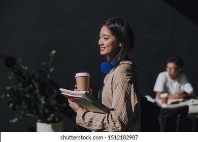 I Like College Life. Pretty Asian Lady With Cupholder Posing For Camera