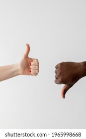 Like Dislike Gesture. Gender Diversity. Versus Opposition. Acceptance Support. Racial Cooperation. Conceptual Art. White Female And Black Male Hands Showing Thumbs Up Down Isolated Light.