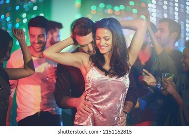 Like No One Else Is Around. Shot Of An Affectionate Young Couple Dancing On A Crowded Dance Floor In A Nightclub.