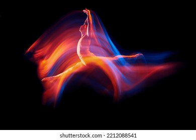 Like a phoenix. Solo performance of flexible adorable male ballet dancer flying isolated on dark background in glowing colorful neon light. Grace, art, beauty, contemp dance, aspiration concept. - Powered by Shutterstock