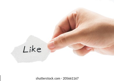 Like Us On Facebook Concept Using A Hand Holding A Piece Of Paper And The Text Written By Hand With A Permanent Marker