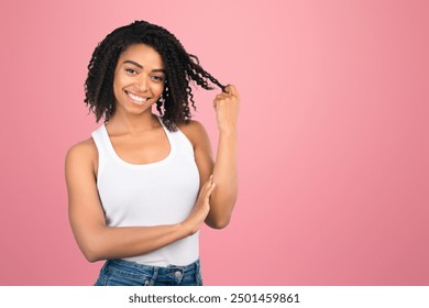 I Like You. Beautiful afro woman twirling hair, playing with her curls on a date, smiling at camera at studio, copyspace - Powered by Shutterstock