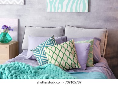 Lilac Accent In Modern Interior. Comfortable Bed With Pillows And Plaid In Room