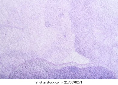 Lilac background, textured paper painted with pastel purple paint in a flowing abstract composition with copy space. A ghostly face floating, a funny creative spooky scene.
