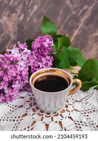 Lilac Branches And Cup Of Coffee On A White Lace Napkin