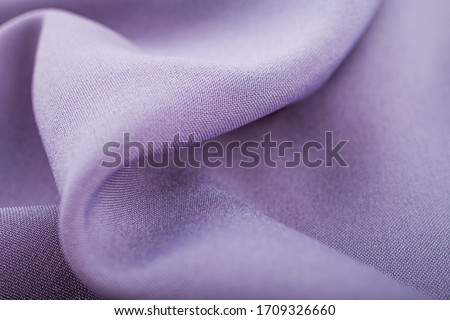 Lilac cloth fabric texture. Beautiful draperies
