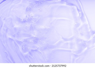 Lilac jelly sanitizer abstract pattern. Cosmetic gel serum background texture. Hyaluronic acid fluid skincare product with bubbles, facial cosmetics with ceramide collagen. Cleansing emulsion macro