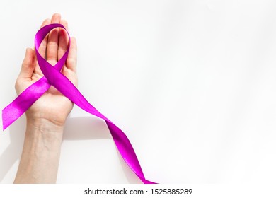 Lilac ribbon in hands is symbol of Alzheimers disease on white background top view copy space - Shutterstock ID 1525885289