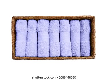 Lilac towels in basket isolated over white background. Color of the year 2022 Very peri toned