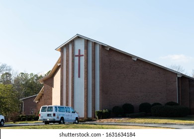 Lilburn,GA / USA - January 30 2020:  Close streetside view Calvary Baptist Church on Lawrenceville Hwy GA with cross on a clear sunlit day.