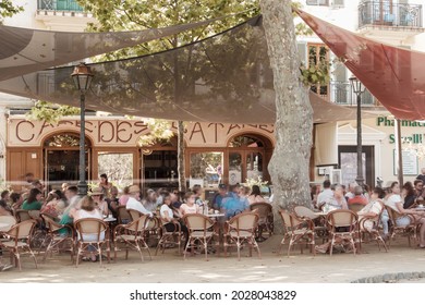 L'Ile Rousse, Corsica, France - 19th August 2021: Holidaymakers relax outside the Café des Platanes at L'ile Rousse in the Balagne region of Corsica
