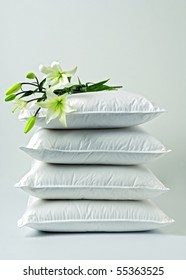 Lilies On A Pile Of White Pillows